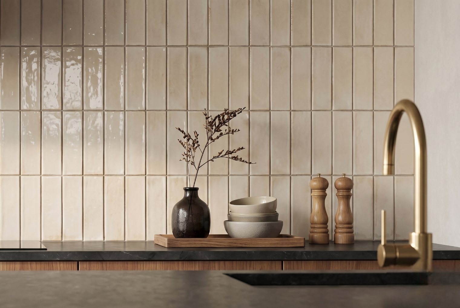 Modern kitchen with vertical cream tiles and gold faucet accents.
