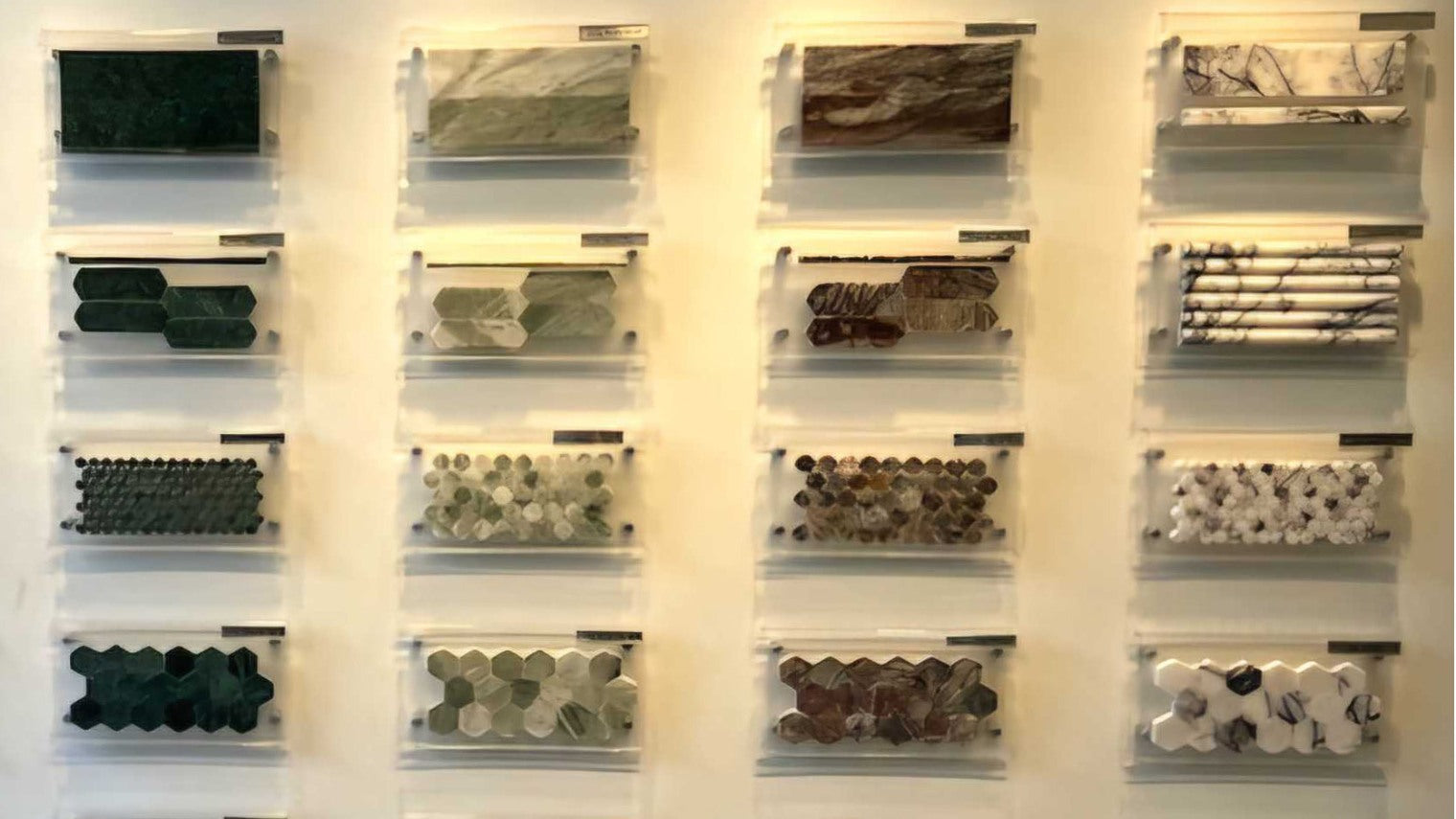  Wall display featuring various marble tile shapes and color samples.