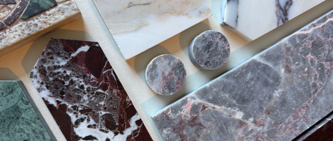 Angular close up of natural architectural stone samples, demonstrating the tactile surface texture of real stone.