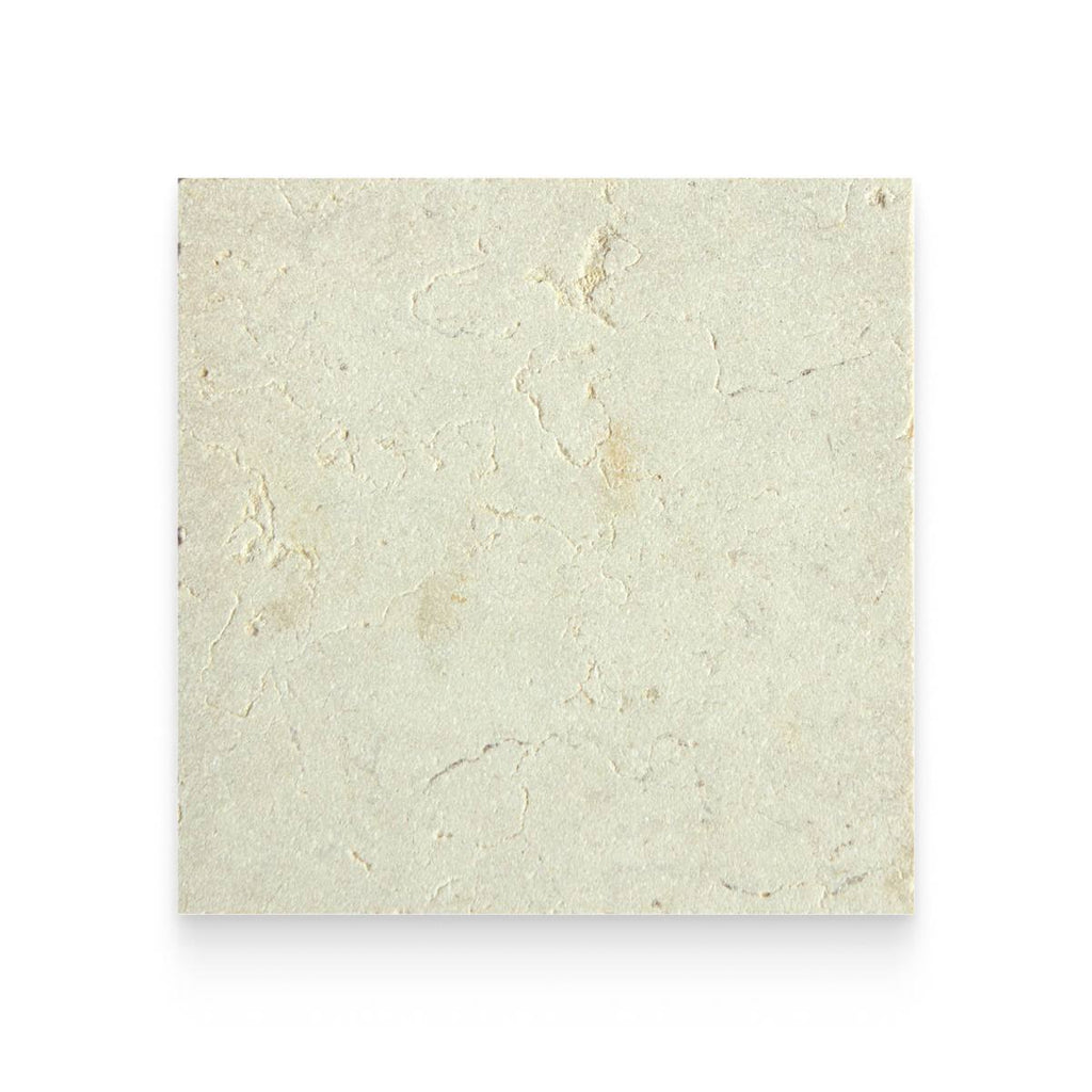 A square sample of light beige limestone tile showcasing natural textures, subtle veining, and organic indentations.
