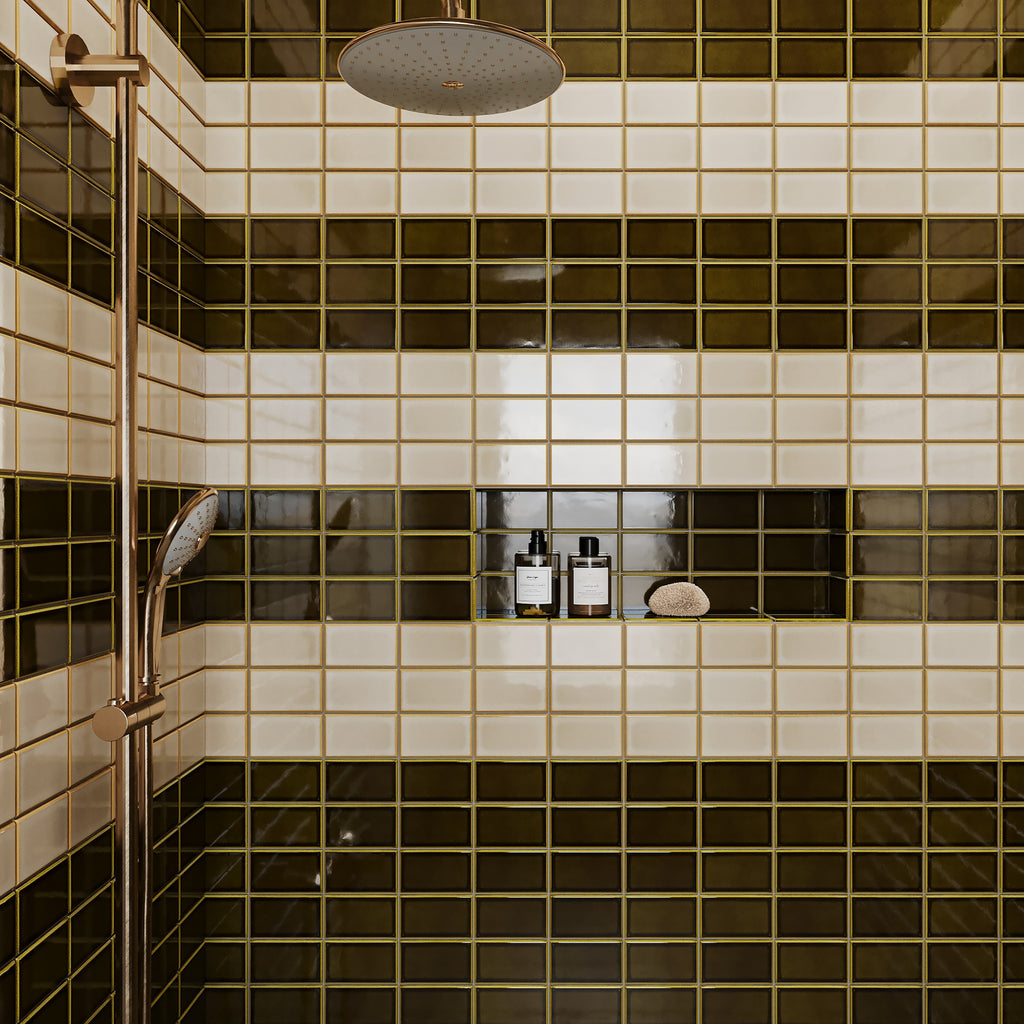 Retro shower design featuring striped olive green and cream subway tiles, a built-in niche, and brushed bronze plumbing fixtures.