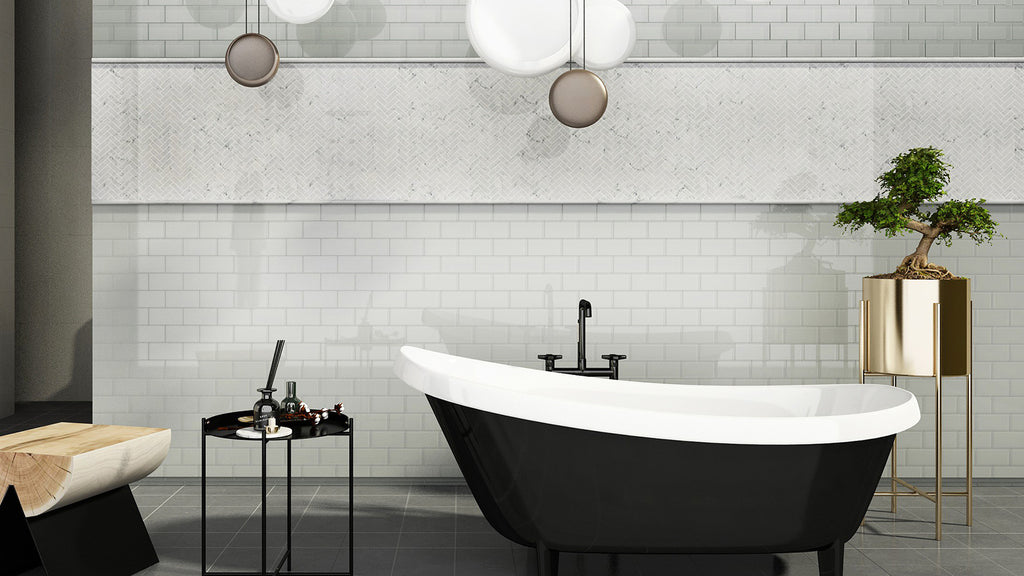 Contemporary bathroom with a black freestanding bathtub, white subway wall tiles, and a custom marble mosaic border.